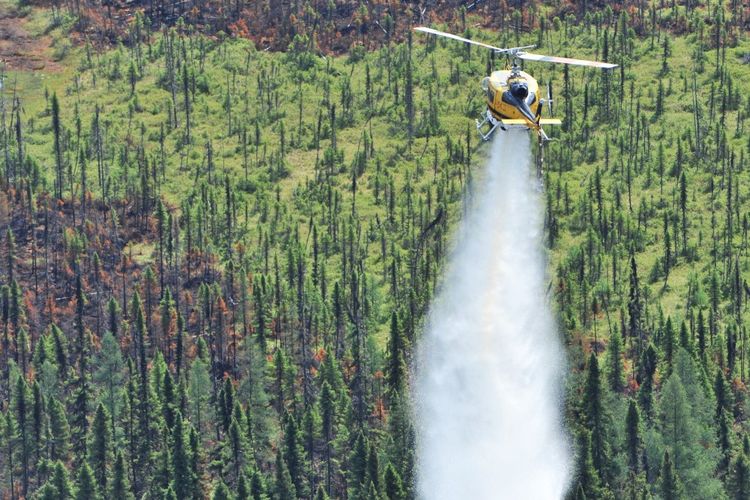 Foto tanggal 4 Juli 2023 yang dirilis oleh Direktorat Jenderal Perlindungan Sipil dan Manajemen Krisis Prancis (DGSCGC) ini menunjukkan sebuah helikopter yang menjatuhkan air ke kebakaran hutan di wilayah Abitibi-Témiscamingue, Quebec, lebih dari 650 km (400 mil) di sebelah utara Montreal. Rekor 22,7 juta acre (9,2 juta hektar) telah terbakar sejauh ini akibat kebakaran hutan yang melanda Kanada, menurut Pusat Kebakaran Hutan Antar-Lembaga Kanada pada 10 Juli 2023.