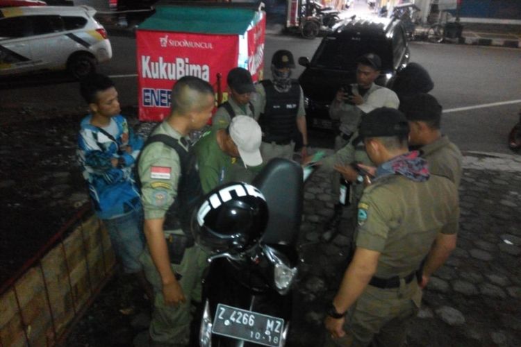 Petugas Satpol PP Kota Tasikmalaya menemukan penjual jamu di pinggir jalan yang menjual miras di kok motor, Sabtu (1/12/2018).