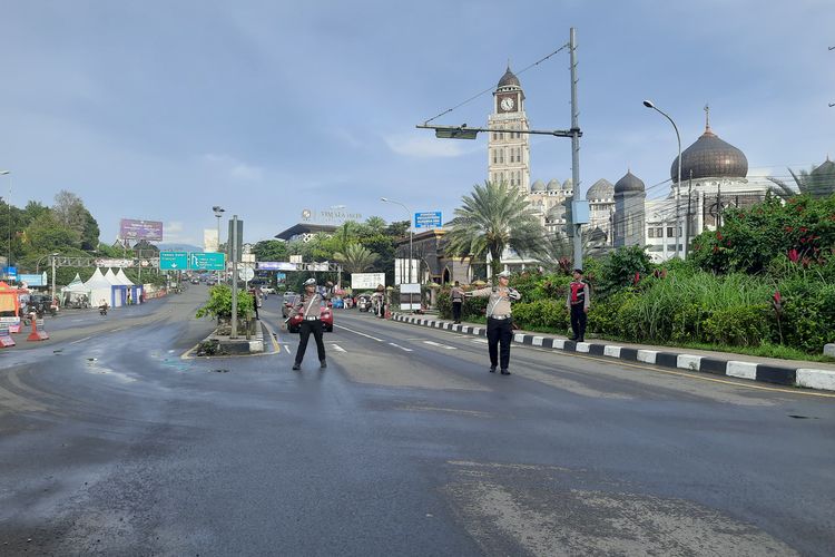 Sejumlah anggota kepolisian sedang mengatur arus lalu lintas di jalur wisata Puncak Bogor, Jawa Barat, Minggu (22/12/2024).