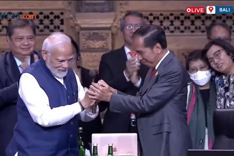 A screen grab from Kompas TV YouTube channel when Indonesia's President Joko Widodo (right) officially handed over the G20 presidency to India's Prime Minister Narendra Modi at the end of the two-day summit at Apurva Kempinski on the island resort of Bali on Wednesday, November 16, 2022.  