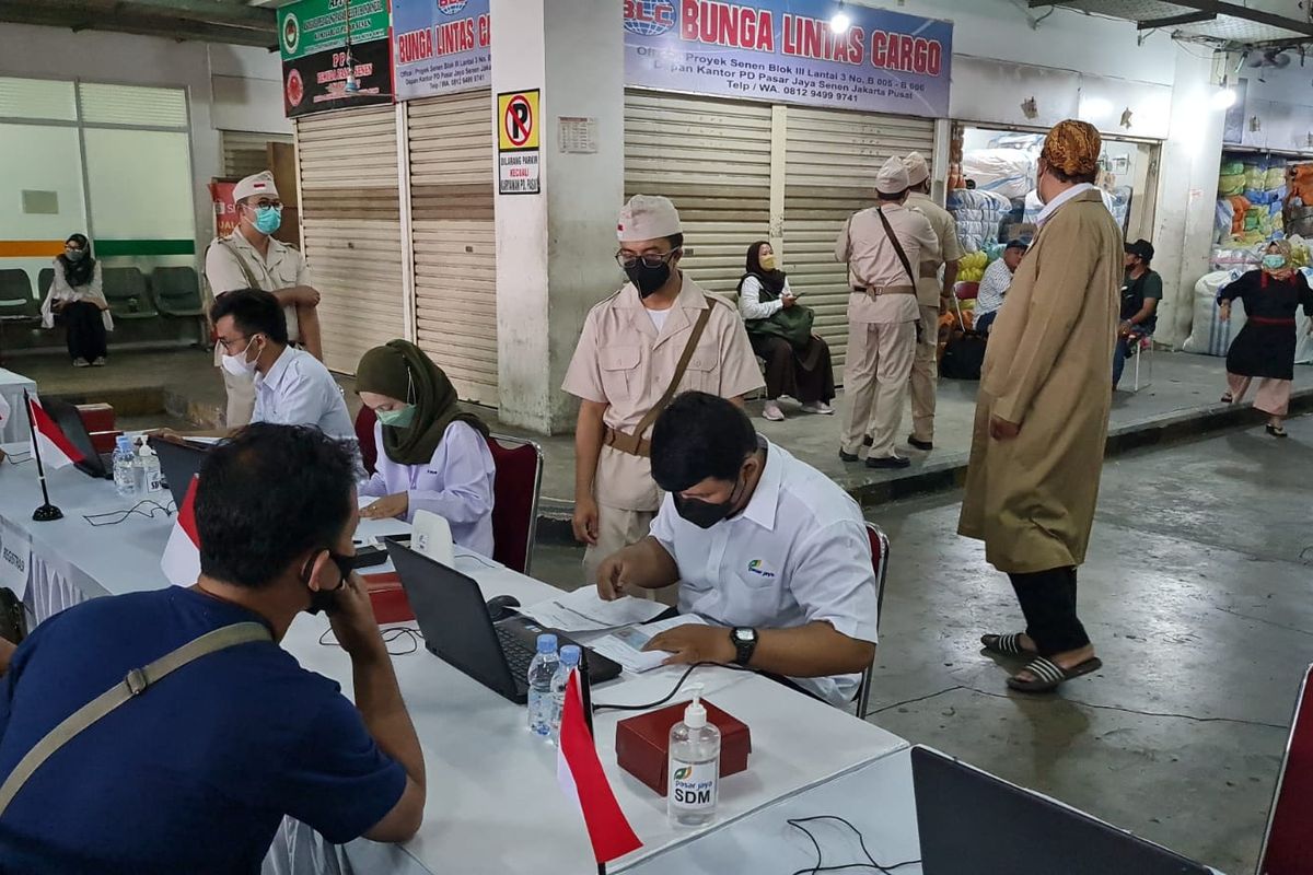 Para petugas Perumda Pasar Jaya mengenakan pakaian ala pahlawan saat mengawasi jalannya vaksinasi pedagang di Pasar Senen blok III, Jakarta Pusat pada pada Rabu (10/11/2021).