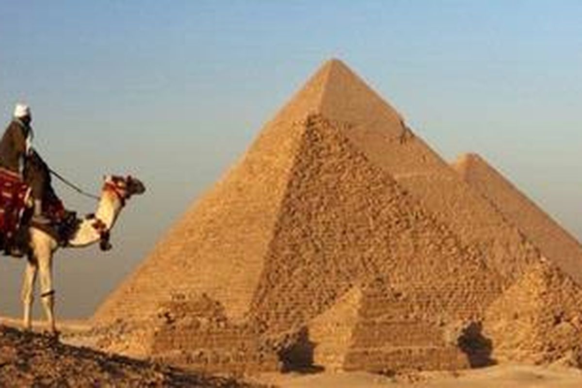 Naik unta keliling piramida di Giza, Mesir.