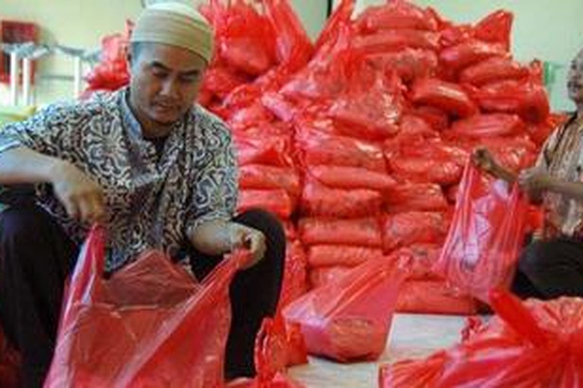 Petugas mengemas paket zakat untuk dibagikan di Kantor Pusat Perum Pegadaian, Jalan Kramat Raya, Jakarta Pusat, Jumat (3/9/2010). Pegadaian menyediakan 1.400 paket zakat berisi lima kilogram beras dan uang Rp 100.000 untuk diberikan kepada warga miskin.