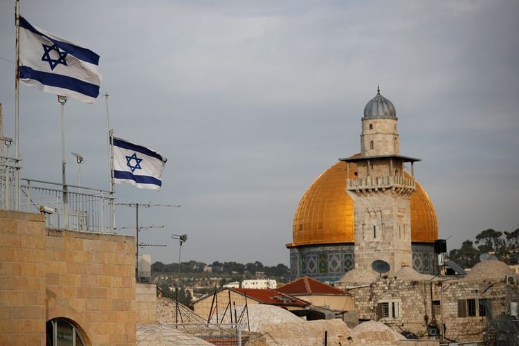 A view of Al-Aqsa Mosque in Jerusalem with Israeli flags flying nearby