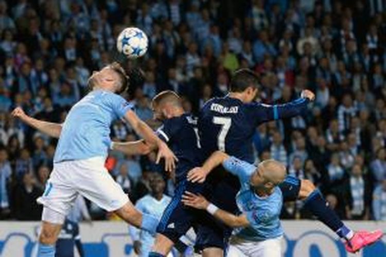 Penyerang Real Madrid Cristiano Ronaldo (2 dari kanan) dan Karim Benzema (2 dari kiri) berduel dengan bek Malmo, Kari Arnason (kiri) dan Anton Tinnerholm, dalam laga penyisihan Grup A Liga Champions di Swedbank Stadion, Malmo, Rabu (30/9/2015).