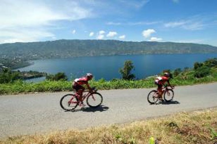 Pebalap sepeda Tour de Singkarak 2013 memacu sepedanya melewati Danau Kembar, Solok, Sumatera Barat, Kamis (6/6/2013). 
