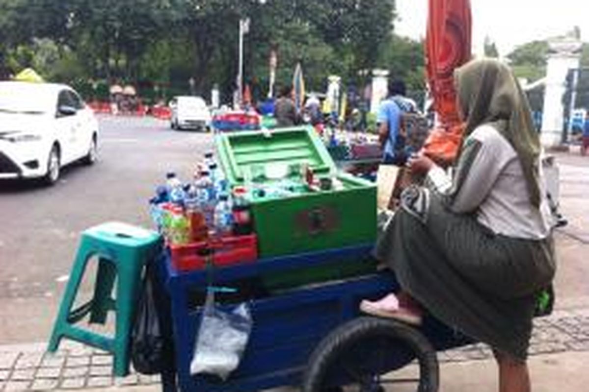 Pedagang kaki lima (PKL) berjualan di luar Pintu Timur Monas, Jakarta Pusat, Selasa (9/12/2014).