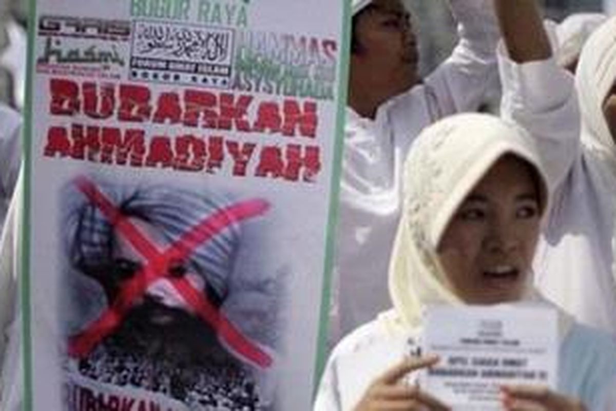 Indonesian Muslims display a defaced poster of Mirza Ghulam Ahmad, the prophet of Ahmadiyah, during a protest demanding the Muslim sect to be banned, in Jakarta, Indonesia, Friday, Feb. 18, 2011. Ahmadiyah, believed to have 200,000 followers in Indonesia, is considered deviant by most Muslims and banned in many Islamic countries because of its belief that Muhammad was not the final prophet. Writings on the poster say: "Ban Ahmadiyah."
