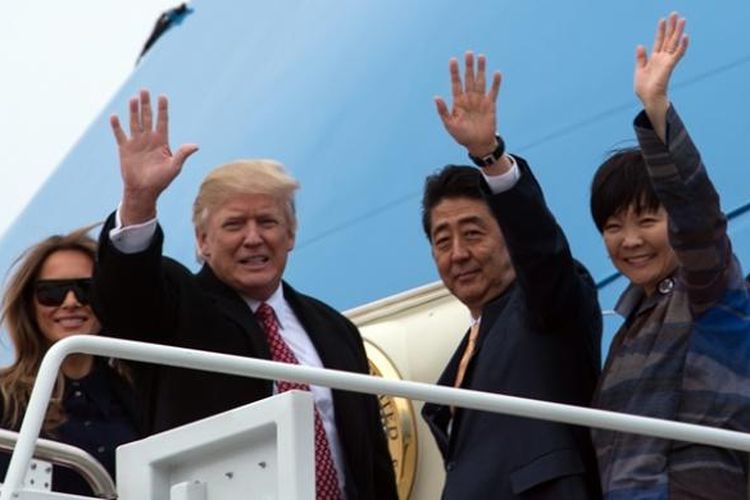 Presiden AS Donald Trump dan PM Jepang Shinzo Abe didampingi istri masing-masing, Melania da Akie sesaat sebelum memasuki pesawat Air Force One di pangkalan militer Andrews, Maryland, Jumat (10/2/2017), untuk menuju ke Florida.