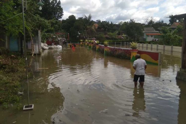 Rumah dan jalan perkampungan di Kelurahan Giritirto, Kecamatan Wonogiri, Kabupaten Wonogiri tergenang setelah pintu air Waduk Gajah Mungkur dibuka.  Buangan air dari Waduk Gajah Mungkur berdampak sungai meluap masuk ke rumah dan jalan perkampungan, Kamis (11/2/2021). 