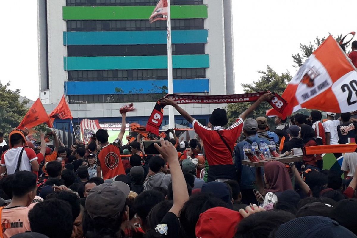 Suporter Persija Jakarta merayakan gelar juara Liga 1 Indonesia musim 2018 yang diraih Persija, Minggu (9/12/2018).