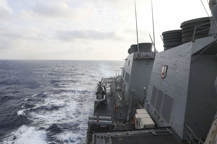 In this photo provided by the U.S. Navy, the Arleigh Burke-class guided-missile destroyer USS Milius (DDG 69) conducts routine underway operations in South China Sea, Friday March 24, 2023. China threatened serious consequences Friday, after the US Navy sailed a destroyer around the disputed Paracel Islands in the South China Sea the second day in a row, which Beijing claimed was a violation of its sovereignty and security.(Mass Communication Specialist 1st Class Greg Johnson/U.S. Navy via AP)