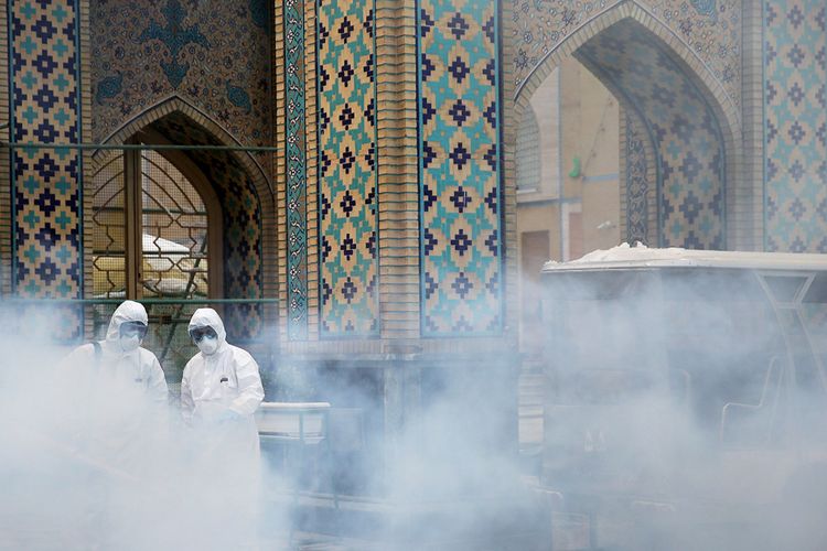 FILE PHOTO: Members of a medical team spray disinfectant to sanitize outdoor place of Imam Rezas holy shrine, following the coronavirus outbreak, in Mashhad, Iran February 27, 2020. Picture taken February 27, 2020. WANA (West Asia News Agency) via REUTERS ATTENTION EDITORS - THIS PICTURE WAS PROVIDED BY A THIRD PARTY/File Photo