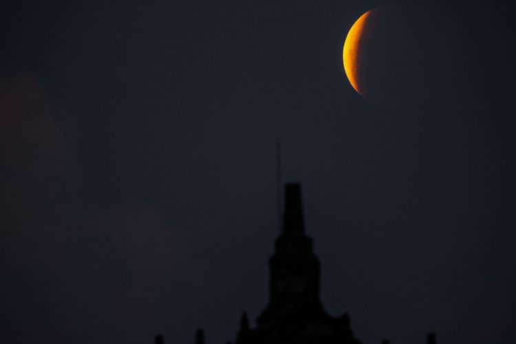 An image of lunar eclipse seen from Plaosan Temple, Prambanan, Central Java on Wednesday, May 26, 2021. 