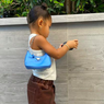 Stormi Webster Kenakan Tas Prada Mini Sporty 