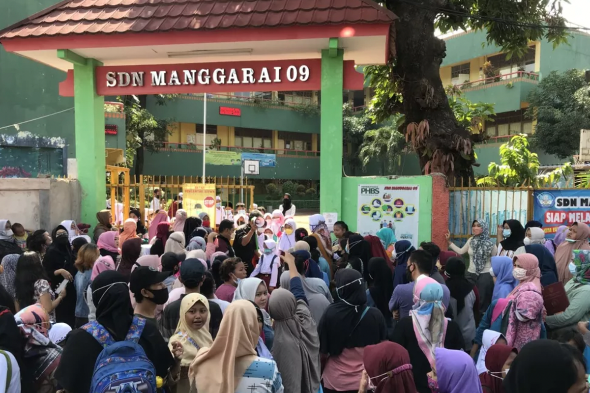 Orangtua murid berkerumun menunggu anaknya pulang sekolah di SDN Manggarai 09, Tebet, Jakarta Selatan, Jumat (7/1/2022).