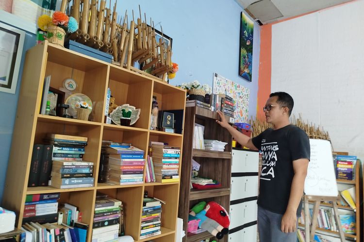 Tunggul Harwanto saat memperlihatkan koleksi buku di rumah baca Rumah Literasi Indonesia. 