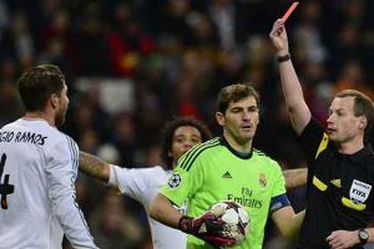 Wasit memberikan kartu merah kepada bek Real Madrid, Sergio Ramos (kiri), dalam pertandingan Liga Champions melawan Galatasaray di Santiago Bernabeu, Rabu (27/11/2013).