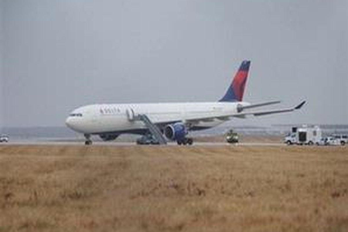 This picture provided by J.P. Karas shows Northwest Airlines Flight 253 on the runway after arriving at Detroit Metropolitan Airport from Amsterdam on Friday, Dec. 25, 2009. A passenger aboard the plane set off firecrackers Friday, causing a commotion and some minor injuries, a Delta official said. Delta and Northwest have merged. 