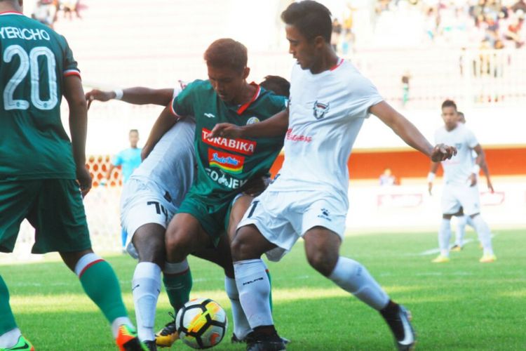 Pemain Madura FC saat berusaha merebut bola dari kaki pemain PSS Sleman.