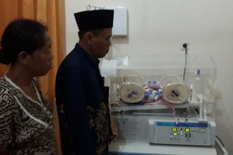 Ketua KPU Lahat Nana Priana saat melihat kondisi bayi perempuan anggota KPPS yang meninggal akibat kelelahan, Jumat (26/4/2019).