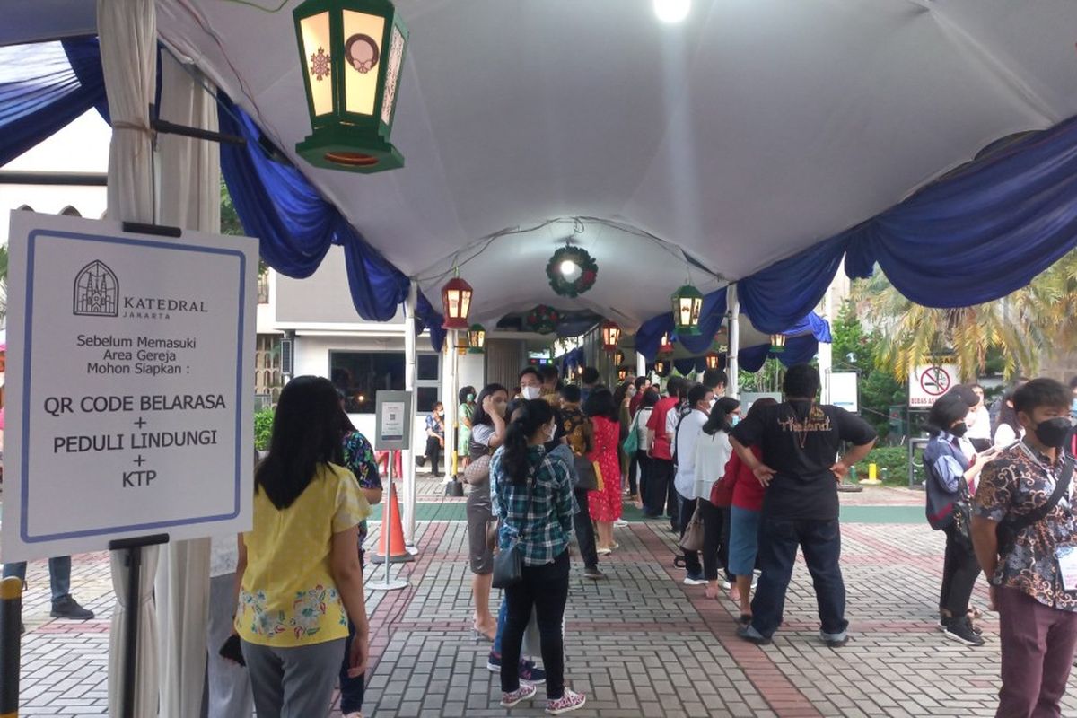 Sejumlah jamaah berbaris untuk memasuki Gereja Katedral, Sawah Besar, Jakarta Pusat untuk mengikuti ibadah tatap muka, Jumat (24/12/2021).