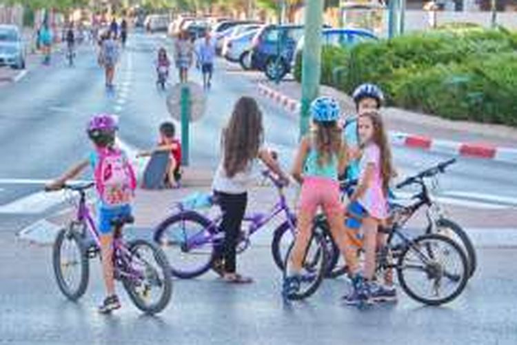 Anak-anak perempuan di Israel sedang bermain sepeda.