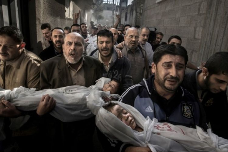 Warga Gaza membawa jenazah Suhaib Hijazi (2 tahun) dan Muhammad (3 tahun), yang tewas di rumah mereka yang hancur dalam serangan rudal Israel, 20 November 2012. Ayah mereka Fouad juga tewas.