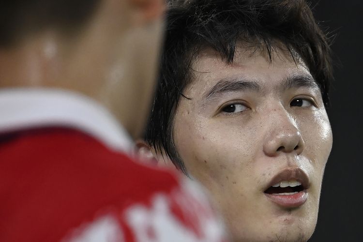 China's Li Junhui reacts after a point with China's Liu Yuchen in their men's doubles badminton quarter final match against Denmark's Kim Astrup and Denmark's Anders Skaarup Rasmussen during the Tokyo 2020 Olympic Games at the Musashino Forest Sports Plaza in Tokyo on July 29, 2021. (Photo by Alexander NEMENOV / AFP)