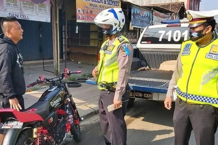 Petugas Ditlantas Polda Banten memberikan sanksi tilang kepada pengendara tidak menggunakan helm