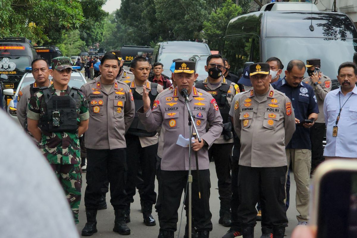 National Police chief General Listyo Sigit Prabowo (center, front) speaks during a press conference outside the Astanaanyar Sub-Precinct Police office in the Indonesian city of Bandung following a suspected suicide bombing on Wednesday, Dec. 7, 2022.  