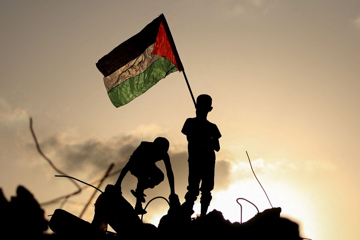 Anak pengungsi mengibarkan bendera Palestina saat berdiri di atas reruntuhan bangunan di kamp pengungsian Bureij, tengah Jalur Gaza, 22 September 2025. Menlu Indonesia Sugiono sebut 10 negara sepakat bentuk tim kecil sebelum 25 September untuk bahas pembentukan negara Palestina pascaperang.