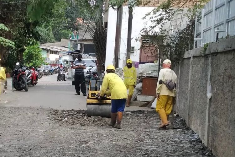 Petugas Sudin Bina Marga Kota Jakarta Utara mengerjakan perbaikan jalan di Jalan Rawa Indah RT 04 RW 03, Kelurahan Pegangsaan Dua, Kecamatan Kelapa Gading, Jakarta Utara, Senin (7/3/2022).