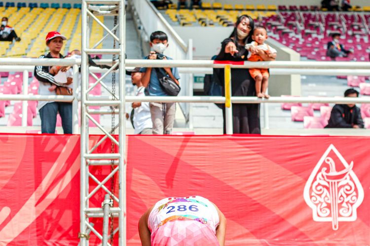 Atlet para atletik Indonesia, M Habib Shaleh, menunduk di hadapan istri dan keluarganya karena gagal finis tiga besar ASEAN Para Games 2022 nomor 200 meter T12 di Stadion Manahan, Solo, Selasa (2/8/2022) siang WIB.
