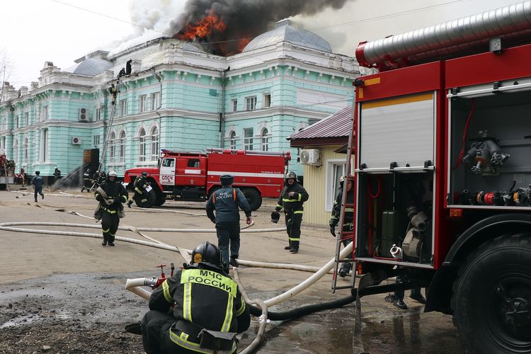 Foto yang dirilis oleh Badan Pers Kementerian Kedaruratan Rusia menunjukkan tim pemadam kebakaran berusaha menjinakkan api di rumah sakit Blagoveshchensk, Rusia, pada 2 April 2021. Sekelompok dokter dan perawat terus melakukan operasi jantung meski api melahap langit-langit Akademi Kardiologi Regional Amur.