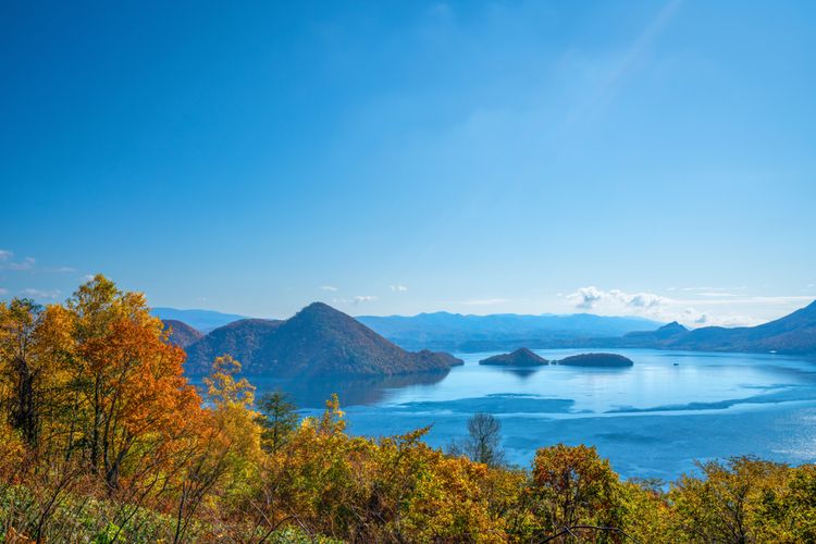 Landskap Danau Toya di Toyako, Hokkaido saat musim gugur. Iklim matahari Jepang menyebabkan negara ini memiliki empat iklim, yaitu musim semi, panas, gugur, dan dingin.