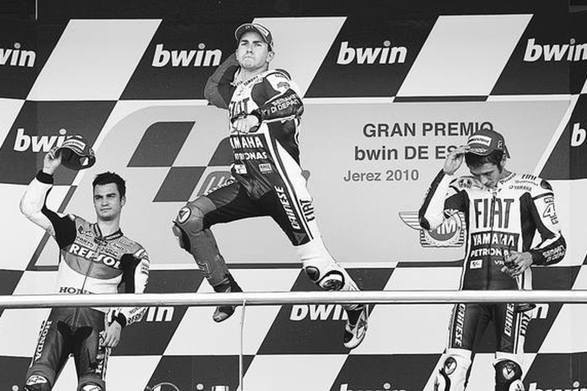 Pebalap Yamaha, Jorge Lorenzo (tengah), meloncat di podium merayakan kesuksesannya pada GP Spanyol di trek balap Jerez, Spanyol, Minggu (2/5). Lorenzo menaklukkan Dani Pedrosa (kiri) dan rekan setimnya, Valentino Rossi.