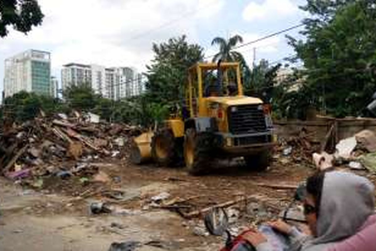 Alat berat dari Dinas Kebersihan terlihat membersihkan puing-puing bekas
penertiban bangunan di pinggir rel Kalibata, Jalan Rawajati Barat, Jakarta
Selatan, Senin (5/9/2016).
