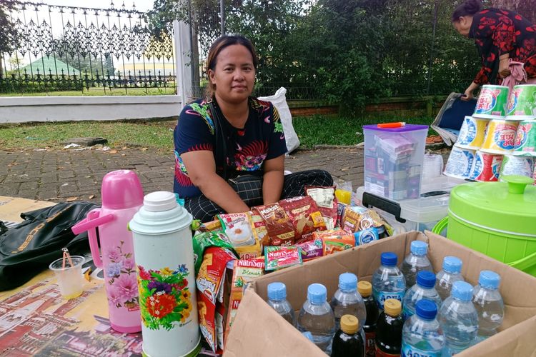 Mai (31), seorang pedagang minuman di sekitar kawasan Taman Mini Indonesia Indah (TMII), Jakarta Timur, Minggu (23/4/2023).