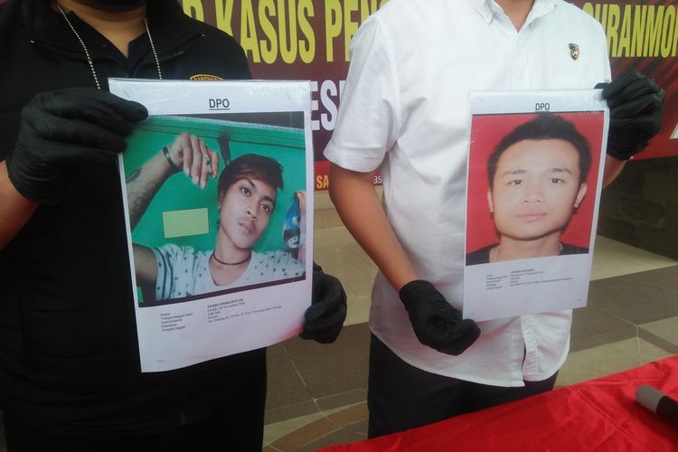 Polisi menunjukkan foto dua pelaku pengeroyokan di Pasar Gadung yang masih buron, pengeroyokan yang menyebabkan penjual nanas tewas di Pasar Gadung, Kecamatan Driyorejo, Gresik, Jawa Timur.