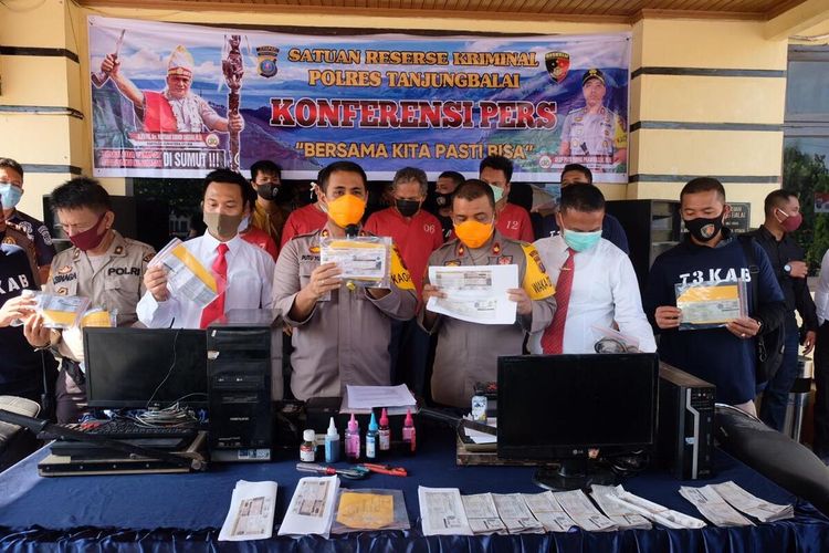 Kapolres Tanjung Balai, AKBP Putu Yudha Prawira bersama jajarannya memaparkan kasus pemalsuan STNK di Tanjung Balai saat konferensi pers di Mapolres Tanjung Balai pada Senin (8/6/2020). Diketahui, Tim Tekab Sat Reskrim Polres Tanjung Balai menangkap Komplotan jaringan sendikat pemalsuan STNK (Surat Tanda Nomor Kendaraan) sepedamotor. Pelaku menjual STNK palsu dengan harga Rp 500.000 per lembar. Sebanyak 168 STNK palsu disita dari komplotan ini.