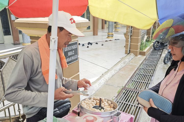 Suwandi saat menjajakan dagangannya ke pelanggan yang ingin menikmati pentol olahannya pada Senin (6/4/2026)
