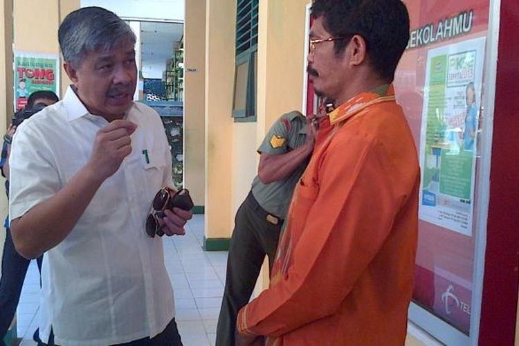 Seorang pengawas Ujian Nasional di SMA Negeri 1 Kendari berbincang dengan Gubernur Sultra, Nur Alam saat memantau pelaksanaan UN 