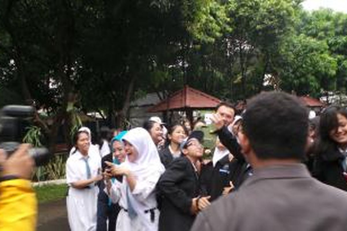 Gubernur DKI Jakarta Basuki Tjahaja Purnama berfoto bersama siswa siswi di SMK Negeri 27, Sawah Besar, Jakarta Pusat, Senin (13/4/2015). Mereka berfoto bersama sebelum melaksanakan Ujian Nasional (UN). 