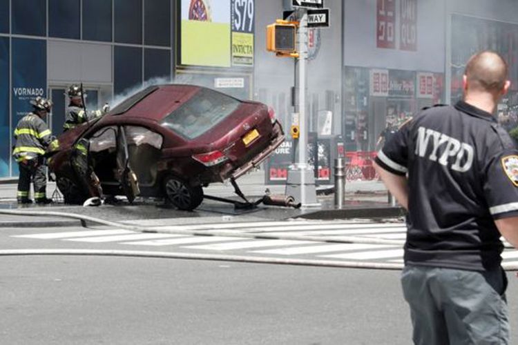 Mobil sedan yang menabrak para pejalan kaki di kawasan kaki lima di Times Square, New York, sedang dalam penanganan petugas. Insiden ini mengakibatkan seorang perempuan tewas dan 23 orang lainnya luka-luka, Kamis (18/5/2017).