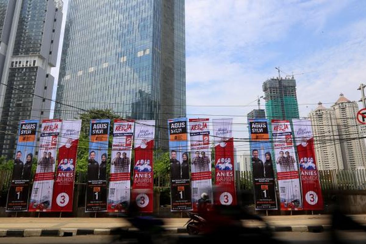 Pengendara sepeda motor melaju di samping baliho bergambar tiga pasangan calon Gubernur dan Wakil Gubernur DKI Jakarta di Jalan Kuningan, Jakarta, Rabu (23/11/2016). KPU DKI Jakarta menyediakan alat peraga kampanye untuk setiap pasangan calon dengan jumlah yang sama, namun apabila masih dirasa kurang mencukupi, masing-masing pasangan calon dibebaskan menambah alat peraga maksimal sebanyak 150 persen dari yang diadakan KPU.