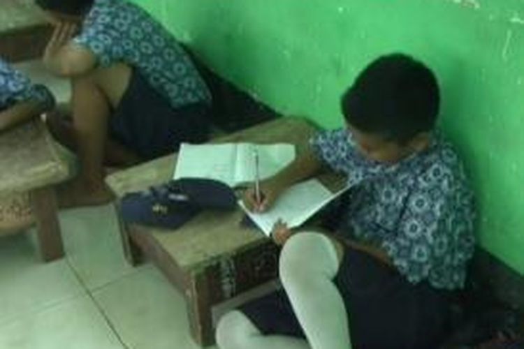 Tak tahan belajar membungkuk di lantai tanpa alas, sejumlah siswa di Mamuju terpaksa bikin meja lesehan agar bisa belajar lebih nyaman.