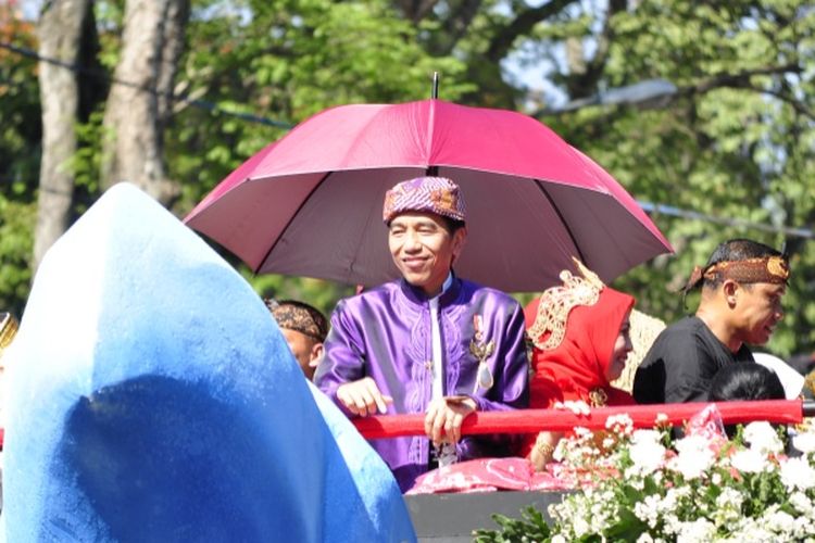 Presiden Joko Widodo saat menaiki kendaraan hias dalam Karnaval Kemerdekaan di Bandung, Jawa Barat, Sabtu (26/8/2017).