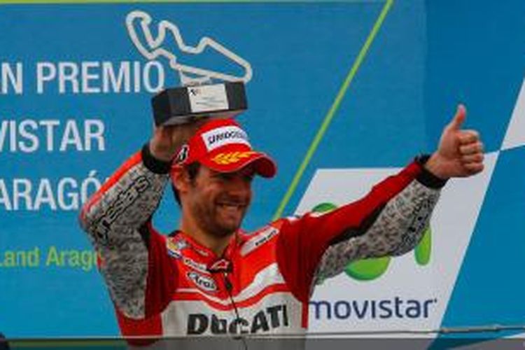 Pebalap Ducati asal Inggris, Cal Crutchlow, mengangkat trofi di atas podium Sirkuit Motorland, setelah finis ketiga pada GP Aragon, Minggu (28/9/2014).