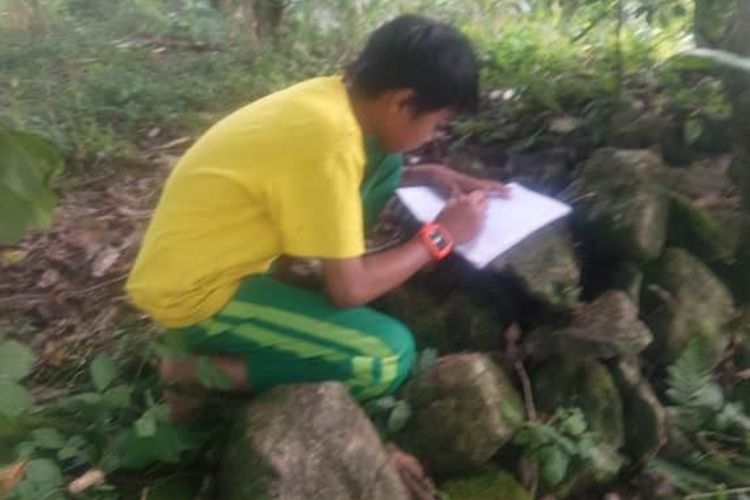 Suasana Firdawasnyah (13) siswa MTs PP Nurul Falah Borongganjeng mengerjakan tugas di Kebun,  Desa Kahayya, Kecamatan Kindang Bulukumba, Sulawesi Selatan.